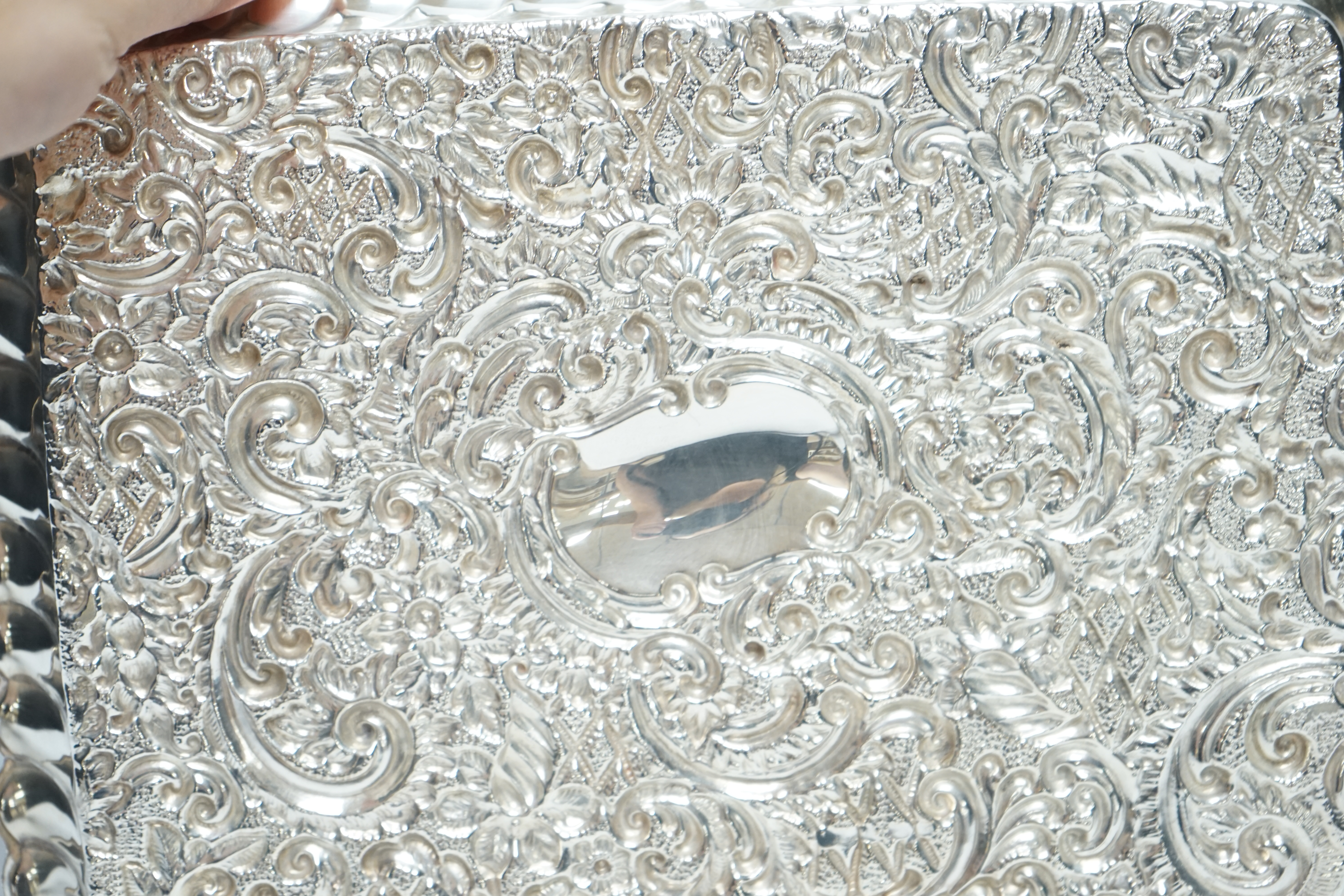 An Edwardian repousse silver dressing table tray, Henry Matthews, Birmingham, 1902, 24.6cm, 6.3oz. Condition - fair